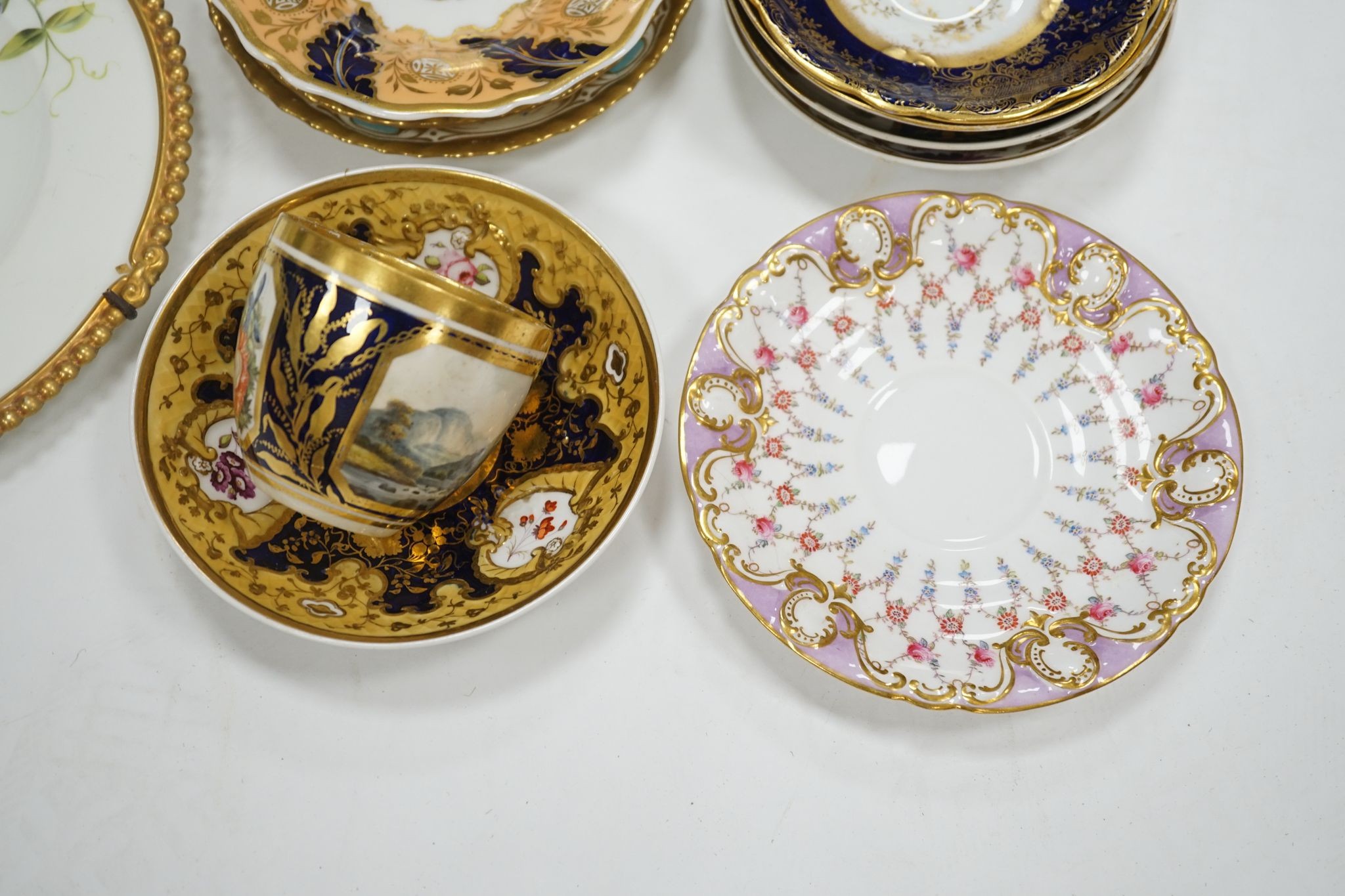 A small collection of Victorian porcelain tea cups and saucers and sundry dessert plates